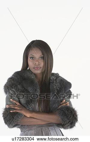 Fashion model stands with arms folded in grey fake fur bolero jacket View Large Photo Image Picture - Fashion model stands with arms folded in grey fake fur bolero jacket. Fotosearch