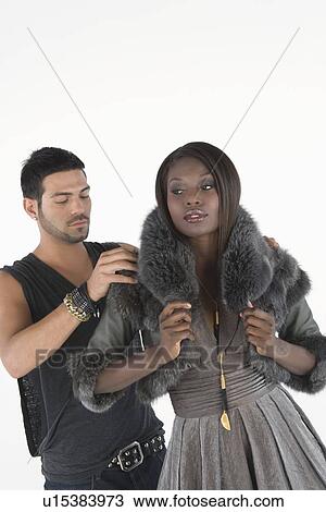 Fashion stylist helps model with fake fur jacket View Large Photo Image Stock Image - Fashion stylist helps model with fake fur jacket. Fotosearch