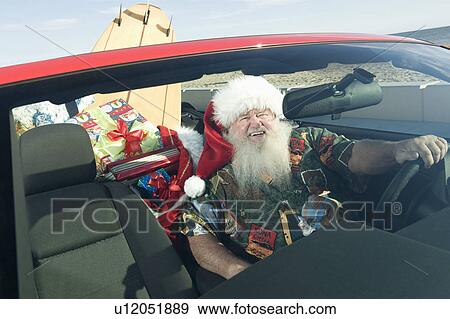Father Christmas sits in red convertible with surfboard View Large Photo Image Stock Photo - Father Christmas sits in red convertible with surfboard. Fotosearch