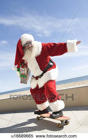 Stock Photography - Father Christmas skateboards. Fotosearch