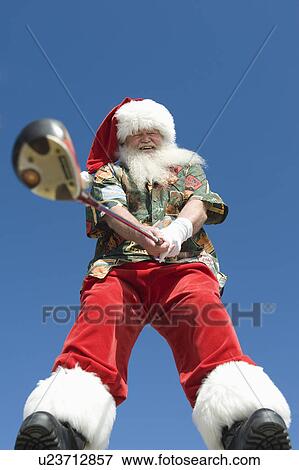 Stock Photo - Father Christmas stands with gold club. Fotosearch