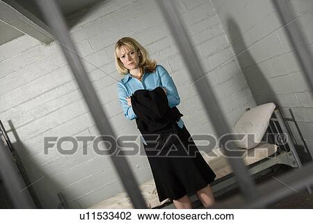 Female criminal behind bars in jail View Large Photo Image Stock Image - Female criminal behind bars in jail. Fotosearch