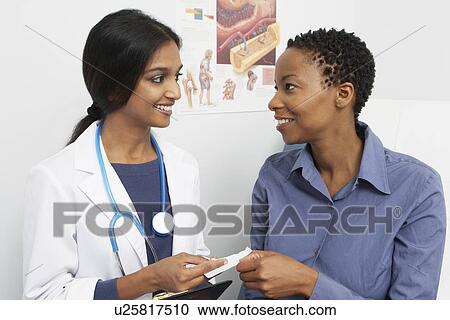 Female doctor and patient smiling View Large Photo Image Stock Image - Female doctor and patient smiling. Fotosearch