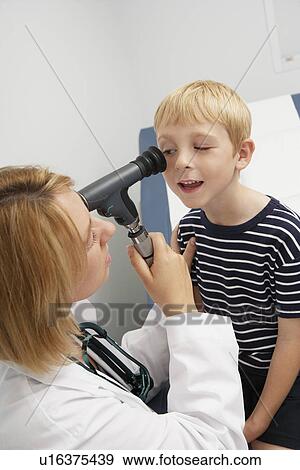Stock Photo - Female doctor examining boy. Fotosearch