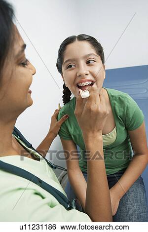 Female doctor examining girl View Large Photo Image Stock Photograph - Female doctor examining girl. Fotosearch