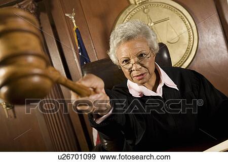 Female judge holding hammer in court View Large Photo Image Stock Photo - Female judge holding hammer in court. Fotosearch