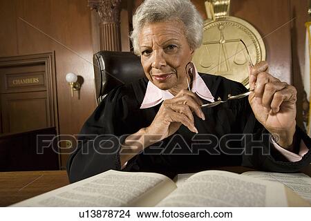 Picture - Female judge sitting in court, portrait. Fotosearch