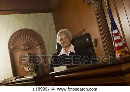 Female judge sitting in court, portrait View Large Photo Image Picture - Female judge sitting in court, portrait. Fotosearch