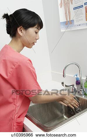 Female nurse washing hands in hospital View Large Photo Image Stock Photograph - Female nurse washing hands in hospital. Fotosearch
