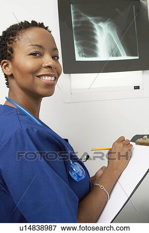 Stock Photo - Female nurse working in hospital, portrait. Fotosearch