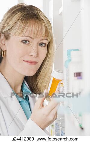 Female pharmactist working in pharmacy View Large Photo Image Stock Photo - Female pharmactist working in pharmacy. Fotosearch