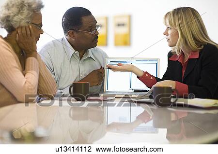 Stock Image - Financial Advisor Assisting Senior Couple. Fotosearch