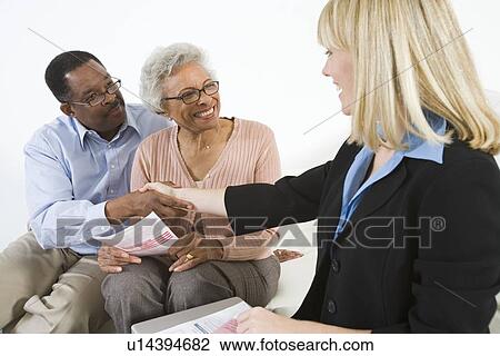 Stock Image - Financial Advisor Assisting Senior Couple. Fotosearch