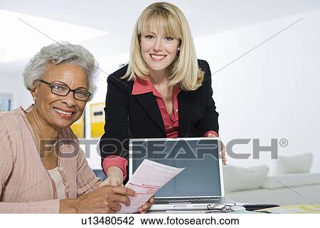 Stock Image - Financial Advisor Assisting Senior Woman. Fotosearch