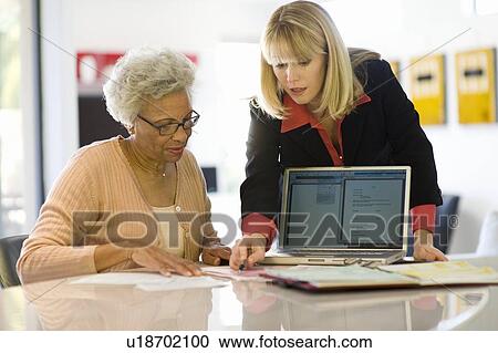 Stock Image - Financial Advisor Assisting Senior Woman. Fotosearch