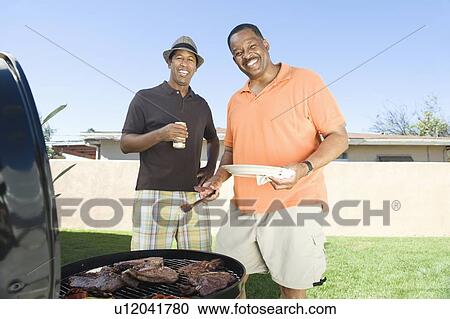 Stock Image - Friends at a barbeque. Fotosearch