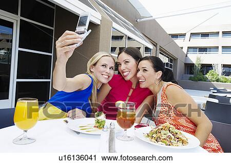 Stock Image - Friends Taking a Self-Portrait. Fotosearch