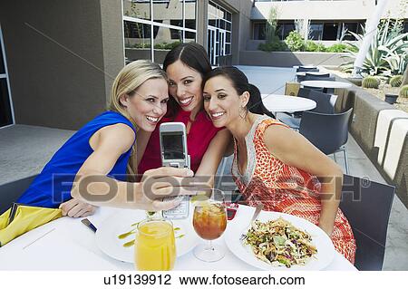 Stock Image - Friends Taking a Self Portrait. Fotosearch
