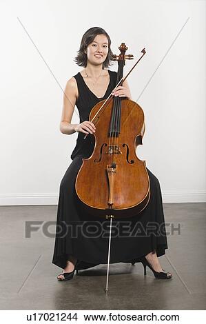 Picture - Full length portrait of cello player. Fotosearch