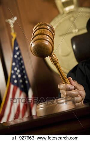 Gavel in judge's hand View Large Photo Image Stock Image - Gavel in judge's hand. Fotosearch