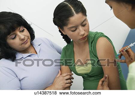 Girl having injection View Large Photo Image Stock Photo - Girl having injection. Fotosearch