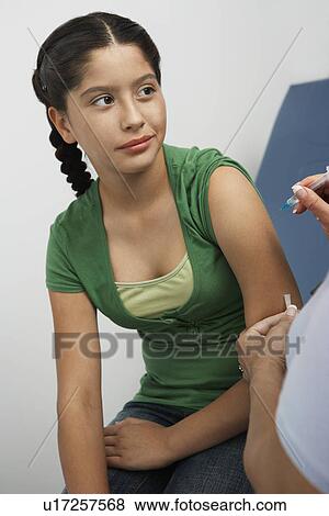 Girl having injection View Large Photo Image Stock Photo - Girl having injection. Fotosearch
