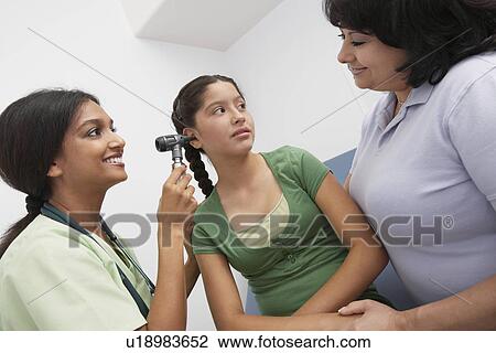 Girl having medical examination at doctors View Large Photo Image Stock Image - Girl having medical examination at doctors. Fotosearch