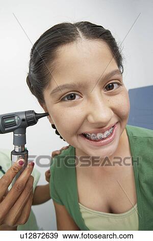 Girl having medical examination View Large Photo Image Stock Photo - Girl having medical examination. Fotosearch