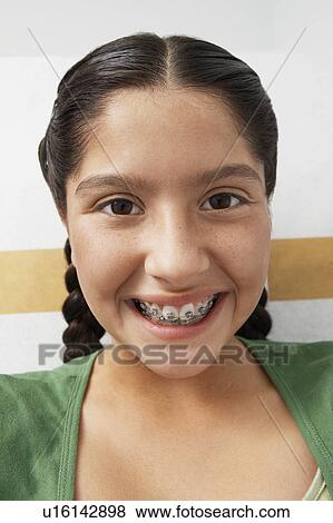 Stock Photo - Girl wearing braces, portrait. Fotosearch
