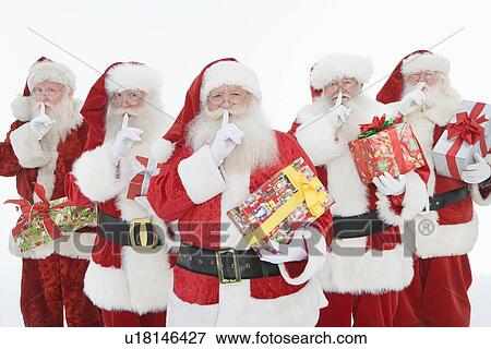 Stock Photo - Group of men dressed as Santa Claus holding gifts. Fotosearch