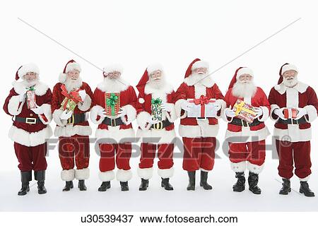 Stock Photo - Group of men dressed as Santa Claus holding gifts. Fotosearch