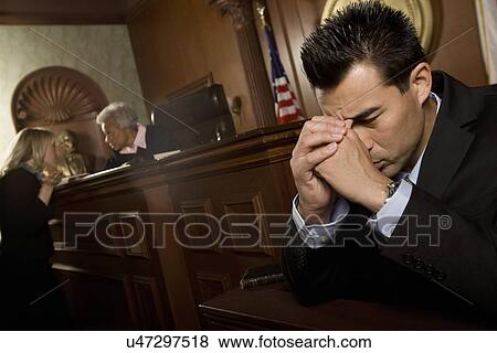 Stock Photo - Guilty man in court room. Fotosearch