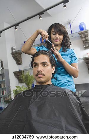 Hairdresser cutting mans hair View Large Photo Image Stock Photo - Hairdresser cutting mans hair. Fotosearch