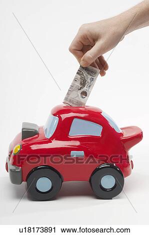 Hand putting banknote into money box View Large Photo Image Stock Image - Hand putting banknote into money box. Fotosearch