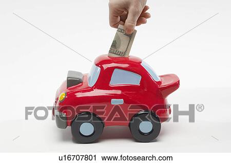 Hand Putting Money in Car Shaped Piggy Bank View Large Photo Image Stock Image - Hand Putting Money in Car Shaped Piggy Bank. Fotosearch