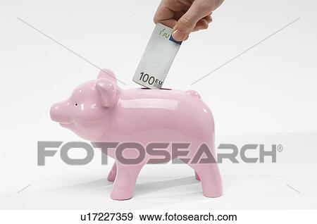 Stock Photo - Hand Putting Money in Piggy Bank. Fotosearch