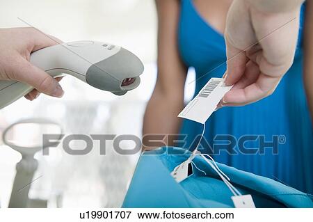 Stock Photo - Hands hold barcode reader. Fotosearch