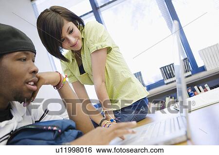Stock Photograph - High School Students Using a Laptop. Fotosearch