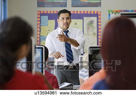 Stock Image - High School Teacher Talking to Class. Fotosearch