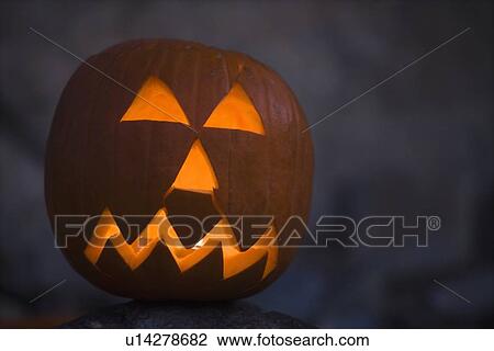 Stock Image - Illuminated jack-o-lantern. Fotosearch
