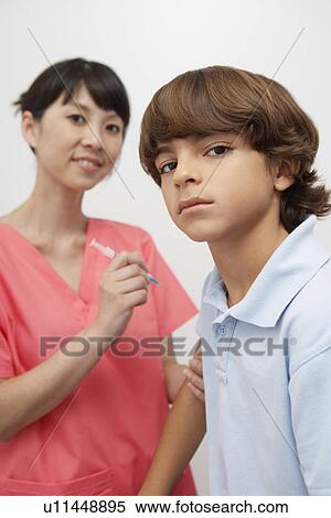 Injection, boy and young nurse View Large Photo Image Stock Photography - Injection, boy and young nurse. Fotosearch