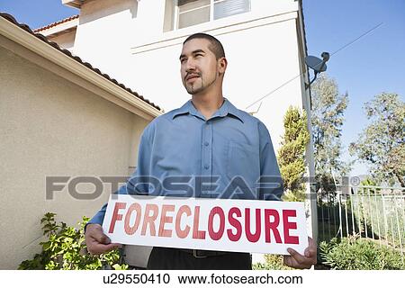 Man holding sign outside house View Large Photo Image Stock Image - Man holding sign outside house. Fotosearch