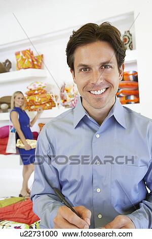 Stock Image - Man Signing a Receipt. Fotosearch