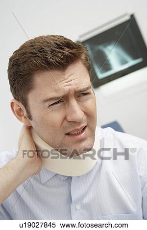 Man wearing neck brace in hospital View Large Photo Image Stock Photography - Man wearing neck brace in hospital. Fotosearch