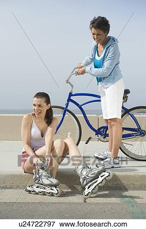 Stock Photo - Mature and mid adult woman prepare for exercise. Fotosearch