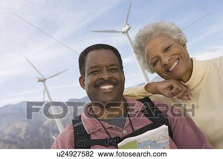 Mature couple with map by wind farm View Large Photo Image Stock Image - Mature couple with map by wind farm. Fotosearch