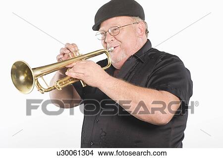 Mature man in flat cap playing the trumpet View Large Photo Image Picture - Mature man in flat cap playing the trumpet. Fotosearch