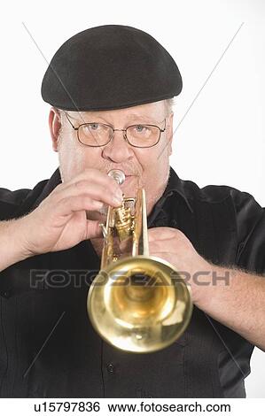 Mature man in flat cap playing the trumpet View Large Photo Image Stock Photograph - Mature man in flat cap playing the trumpet. Fotosearch