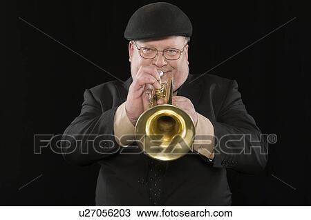Stock Image - Mature man playing the trumpet. Fotosearch