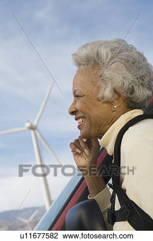 Mature woman by wind farm View Large Photo Image Stock Image - Mature woman by wind farm. Fotosearch